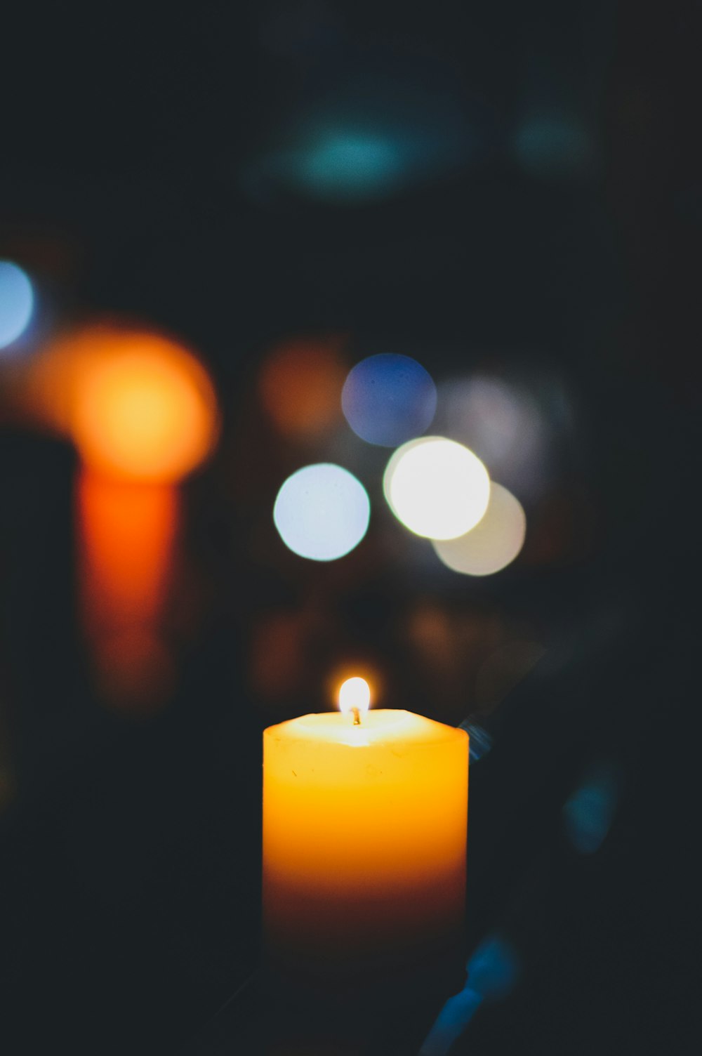 selective focus photography of lighted yellow candle