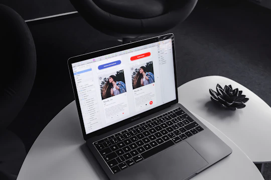 A sleek, modern CV layout displayed on a laptop screen with professional branding elements.