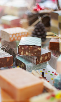 Close-up image of handcrafted soaps and essential oils arranged elegantly on a wooden surface
