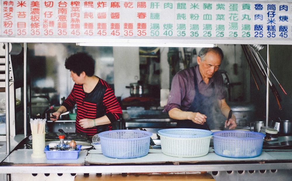 man and woman cooking in kitchen