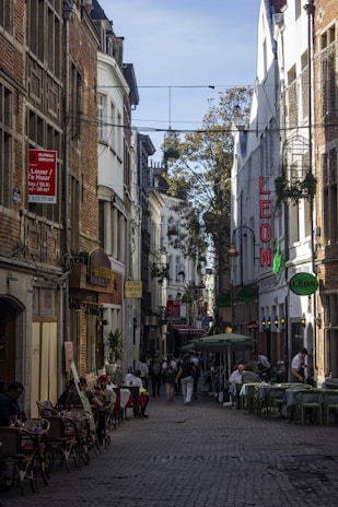 A warm photo of León's historic streets bustling with local people and colorful market stalls.