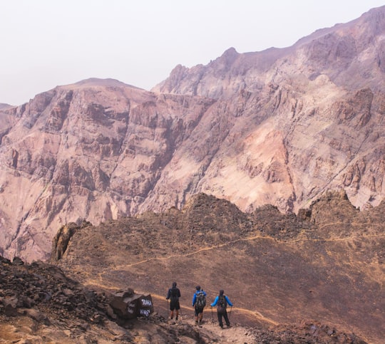 three person standing near mountain in Toubkal Morocco