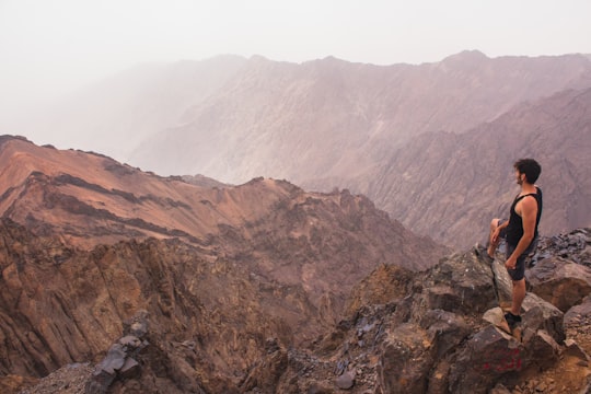 man standing on rock cliff in Toubkal Morocco