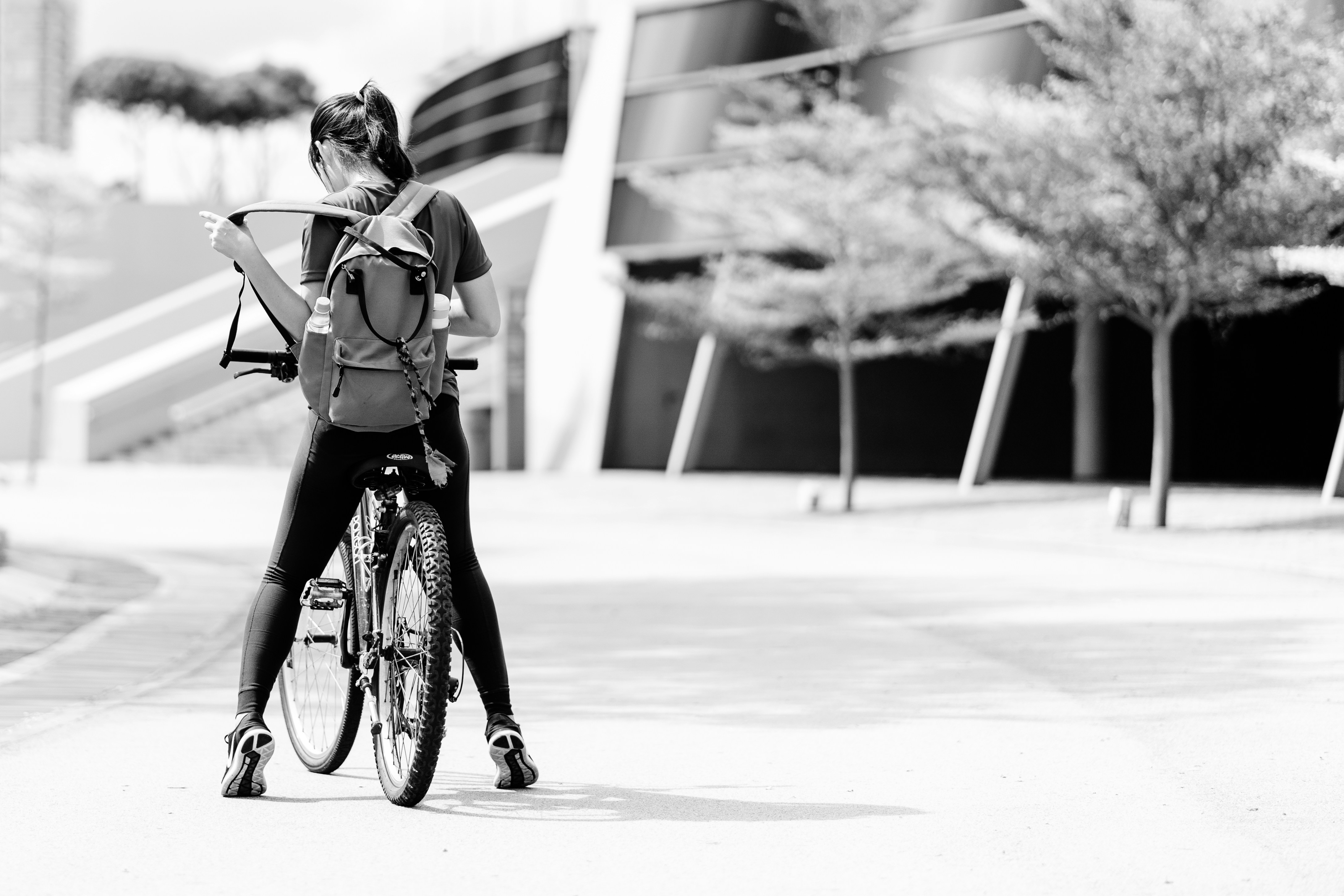 grayscale photo of girl riding bicycle