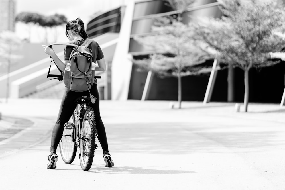 grayscale photo of girl riding bicycle