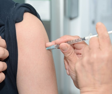 person injecting someone on his arm