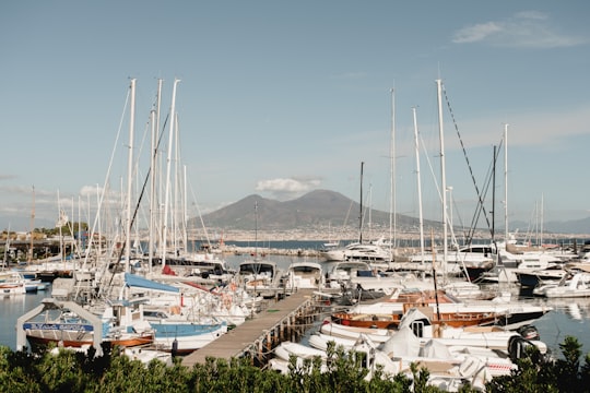 white boat near brown dock in Naples Italy