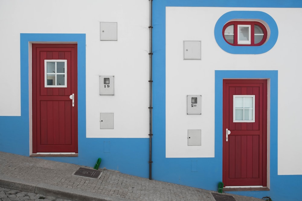 white-blue-and-red houses on inclined street at daytime