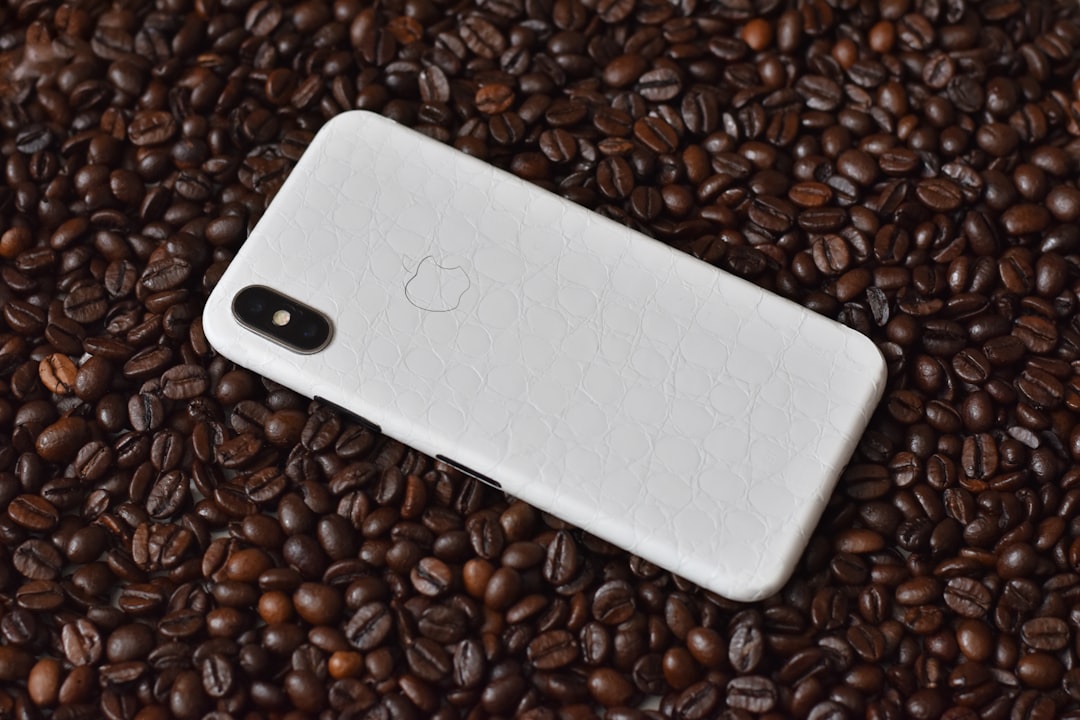 iPhone X with case on brown coffee beans