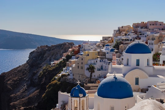 concrete buildings near body of water in Thíra Greece