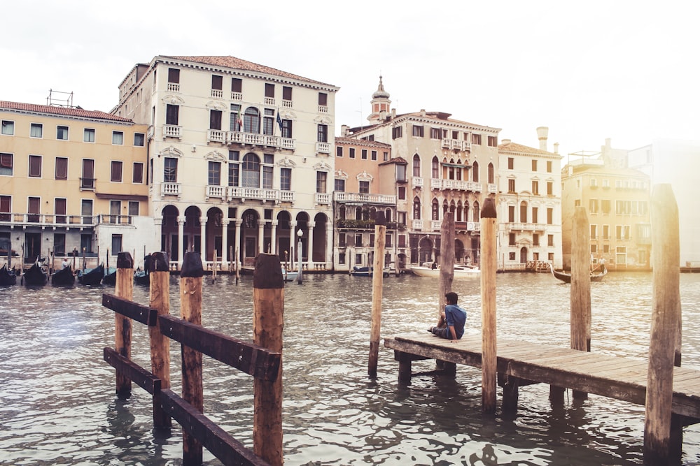 concrete buildings beside body of water