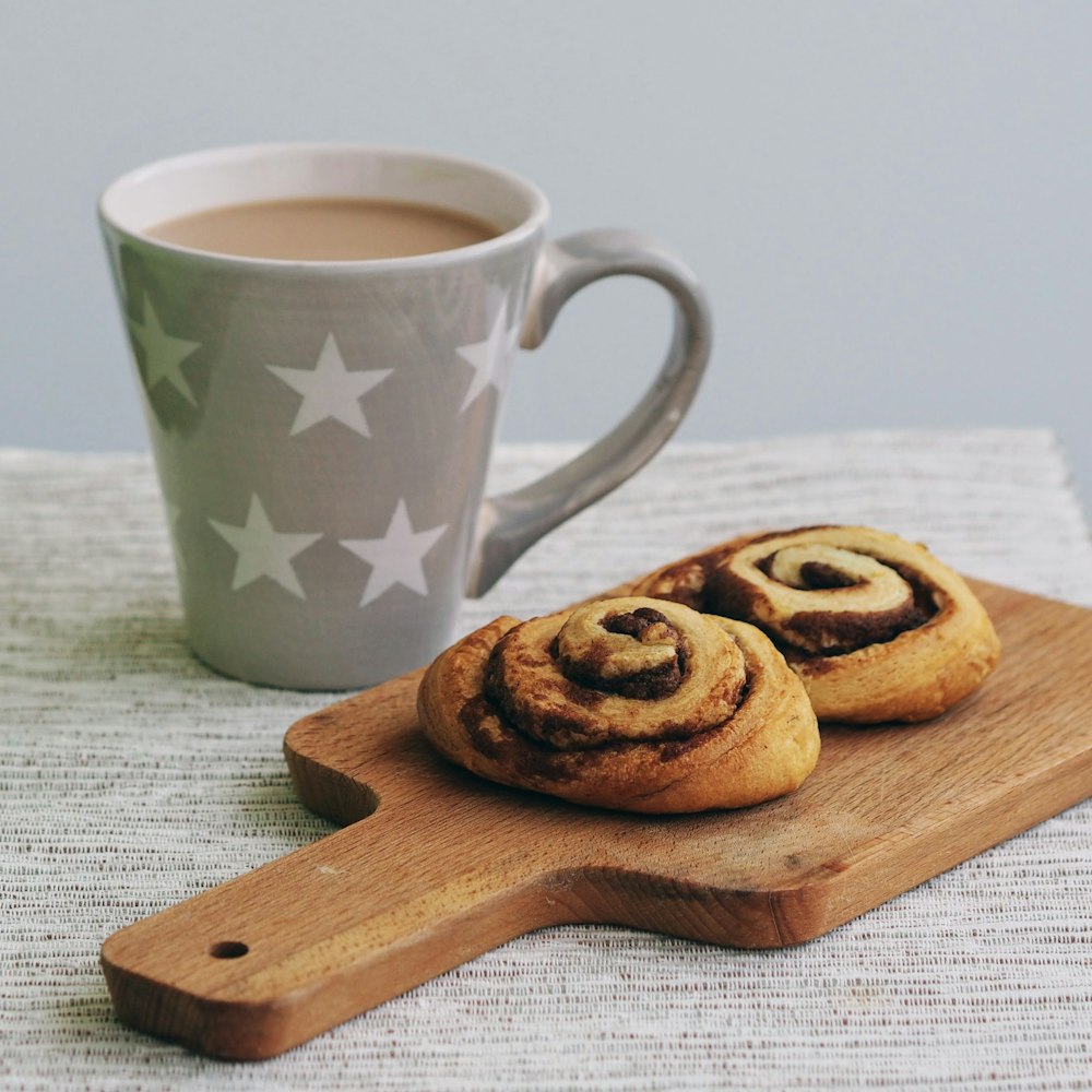 gray and white star print mug and two baked breads