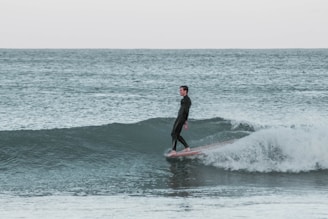 A beginner surfer enjoying a stable ride on a surfboard.