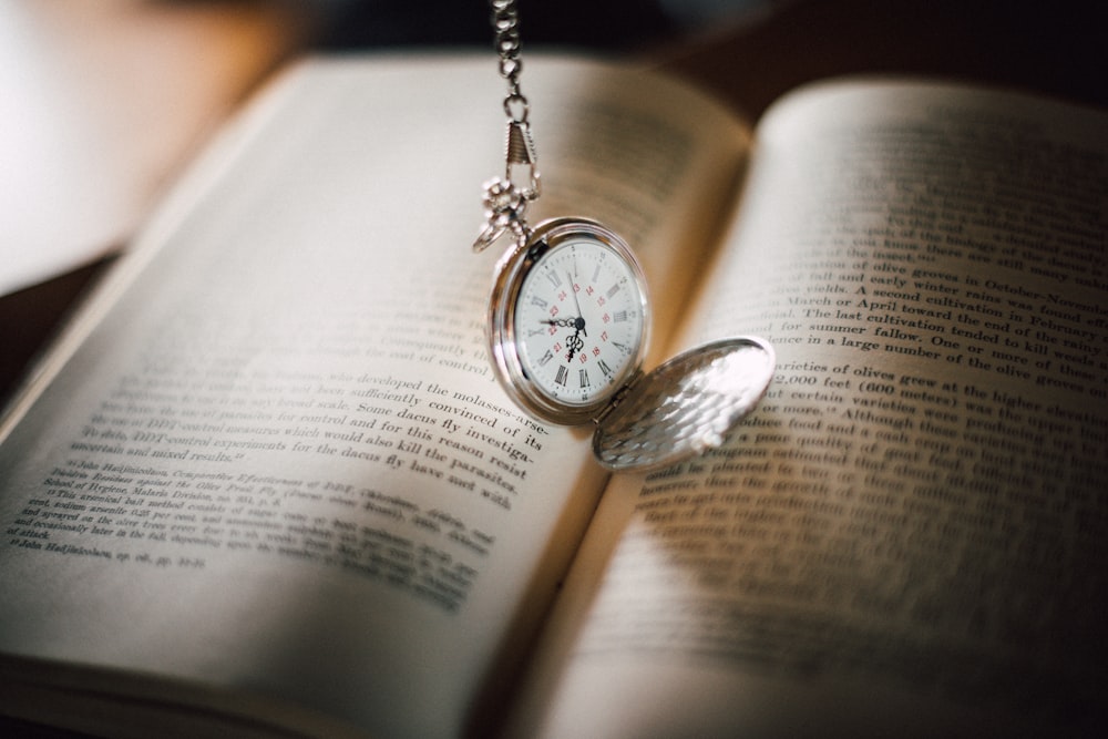 round silver-colored analog watch with link bracelet