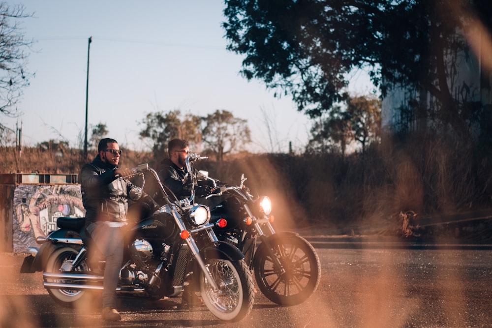 two man riding cruiser motorcycle