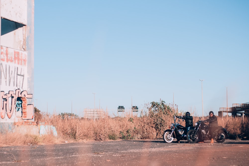 two black motorcycle on pavement