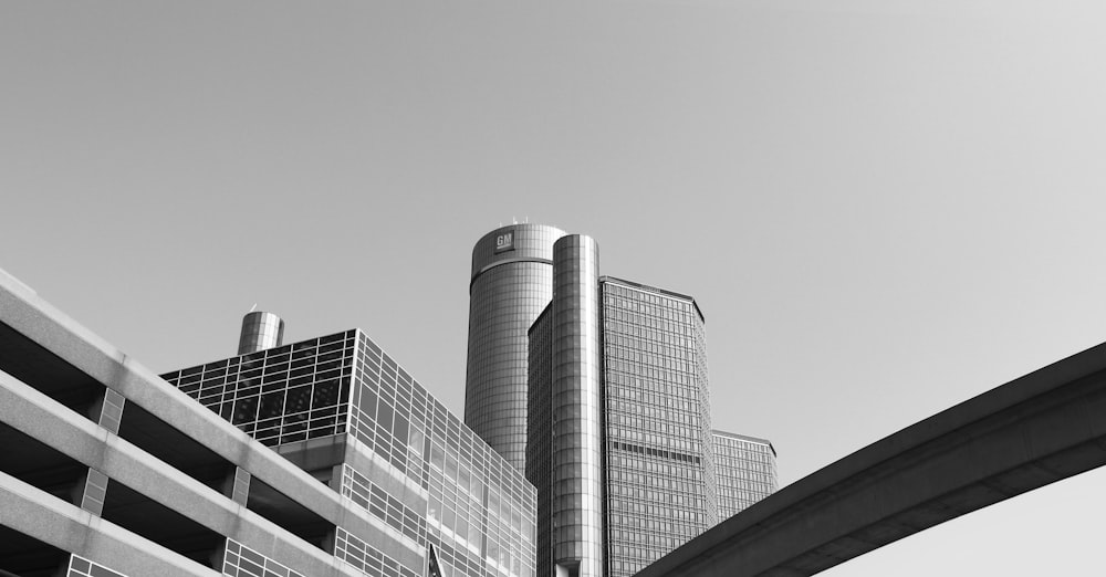 greyscale photography of high rise buildings and bridge