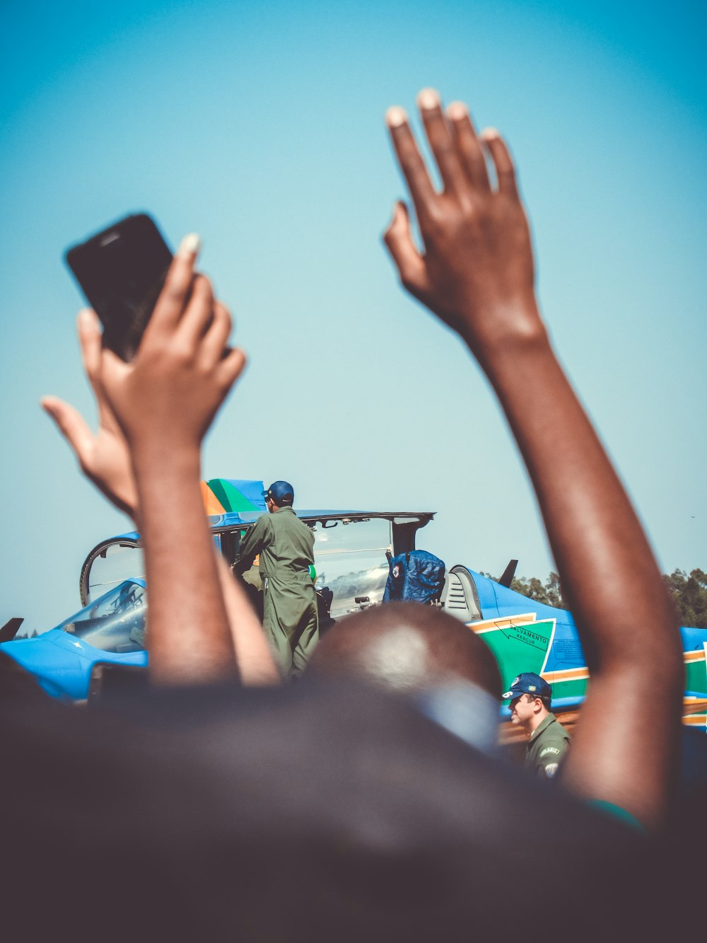 a group of people raising their hands in the air