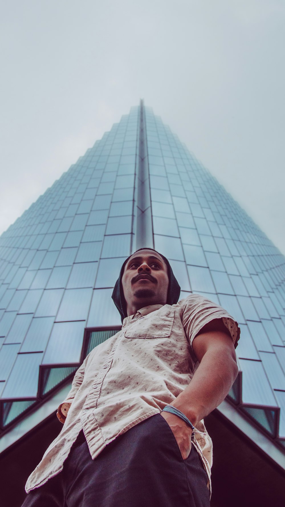 man standing beside building
