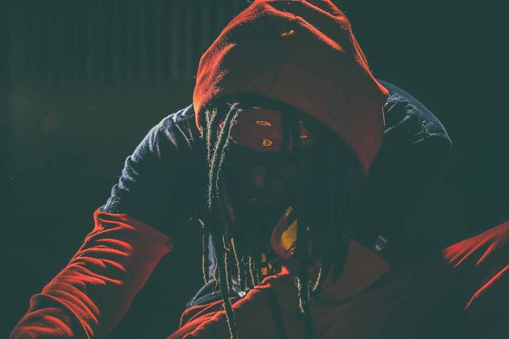 person wearing red and black pullover hoodie