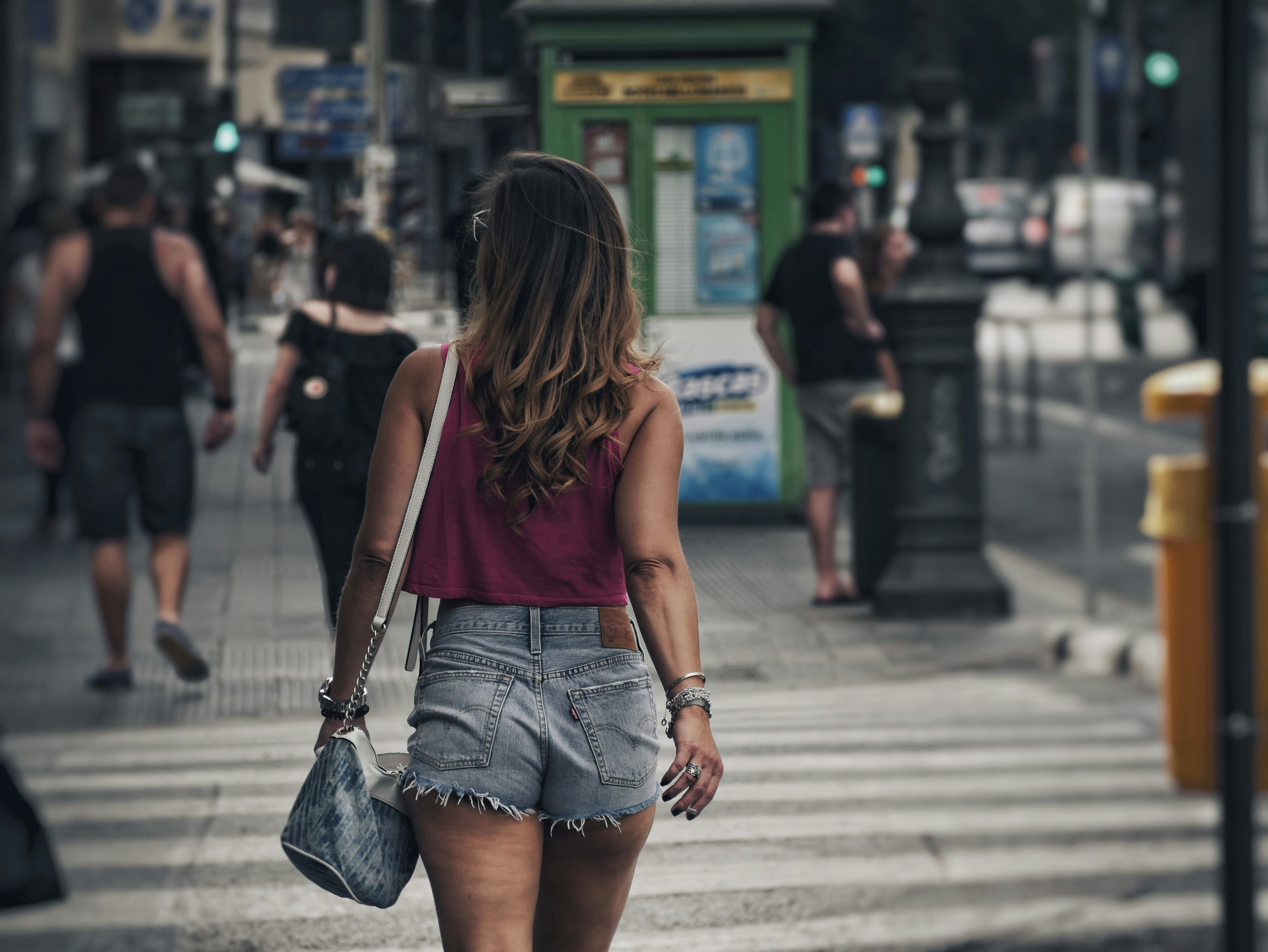 woman walking on lane during daytime