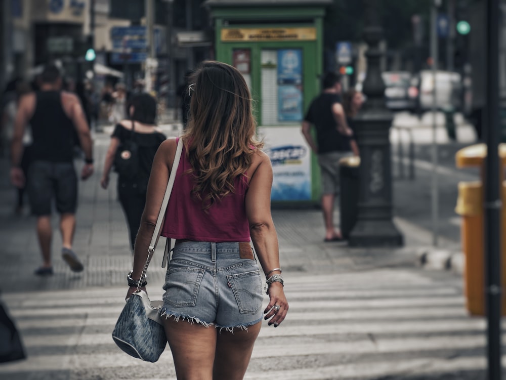 woman walking on lane during daytime