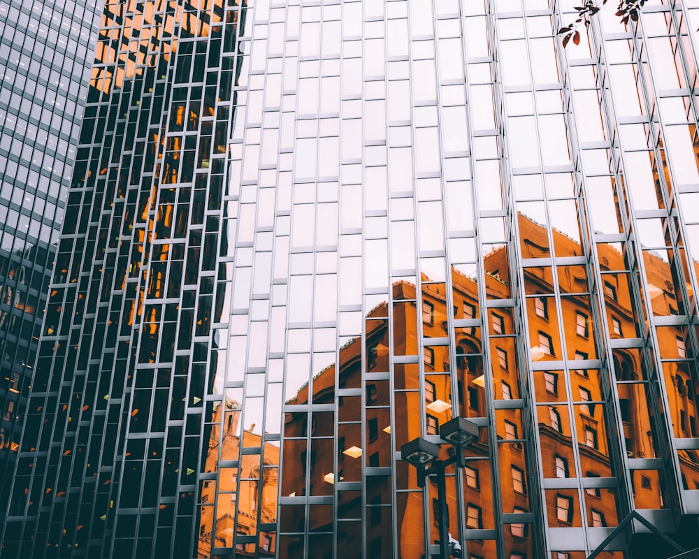 mirror building with reflection of orange painted building