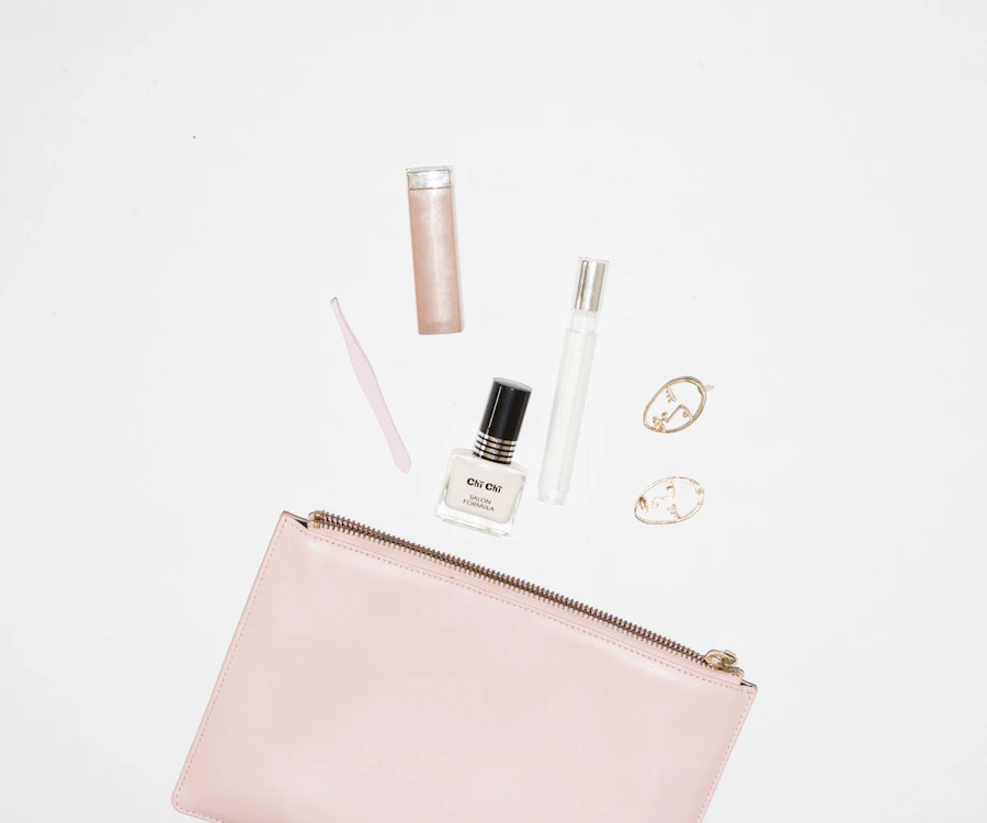 white nail polish bottle and pink leather zip pouch