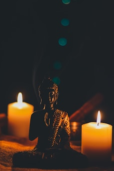 A serene setting with soft candlelight illuminating a peaceful face in meditation.