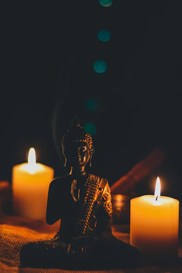 A serene statue of the goddess Lakshmi surrounded by soft candlelight in a meditation space.
