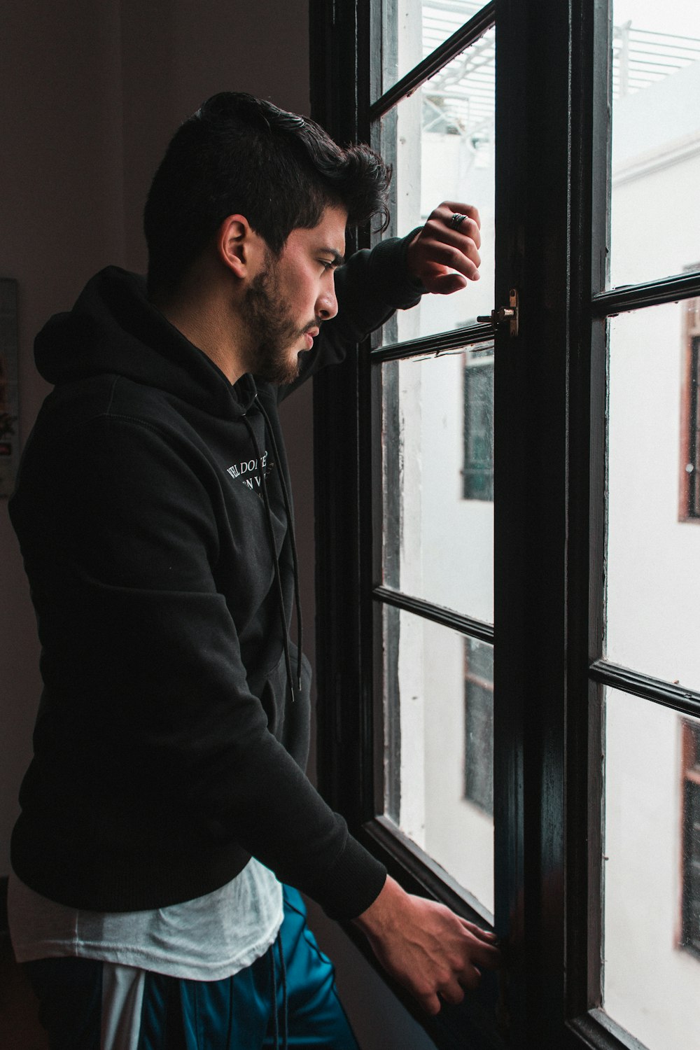 man standing in front of window