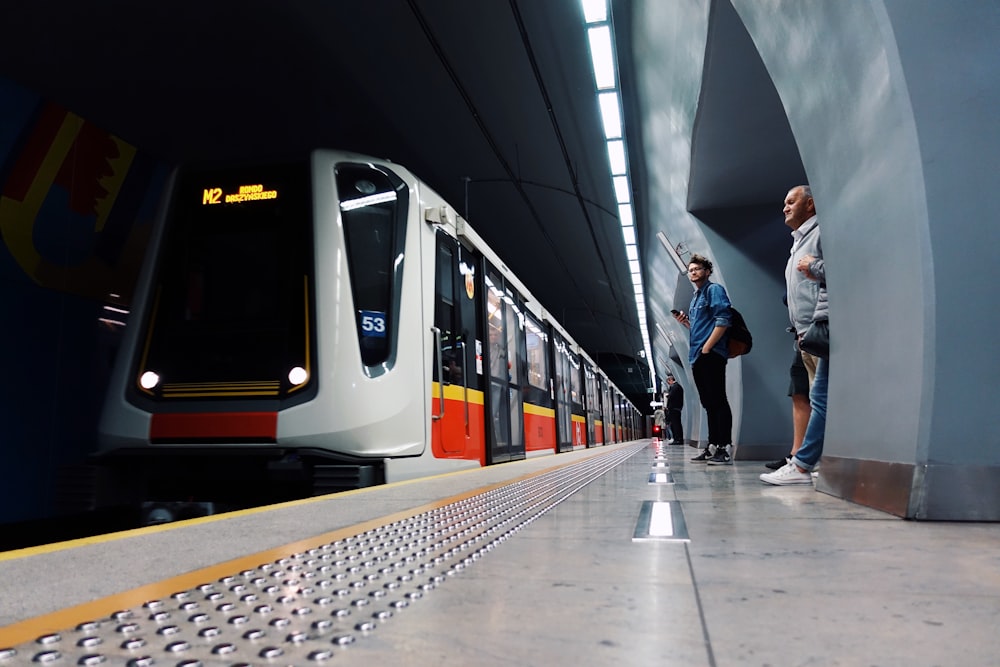 two men waiting at underground train