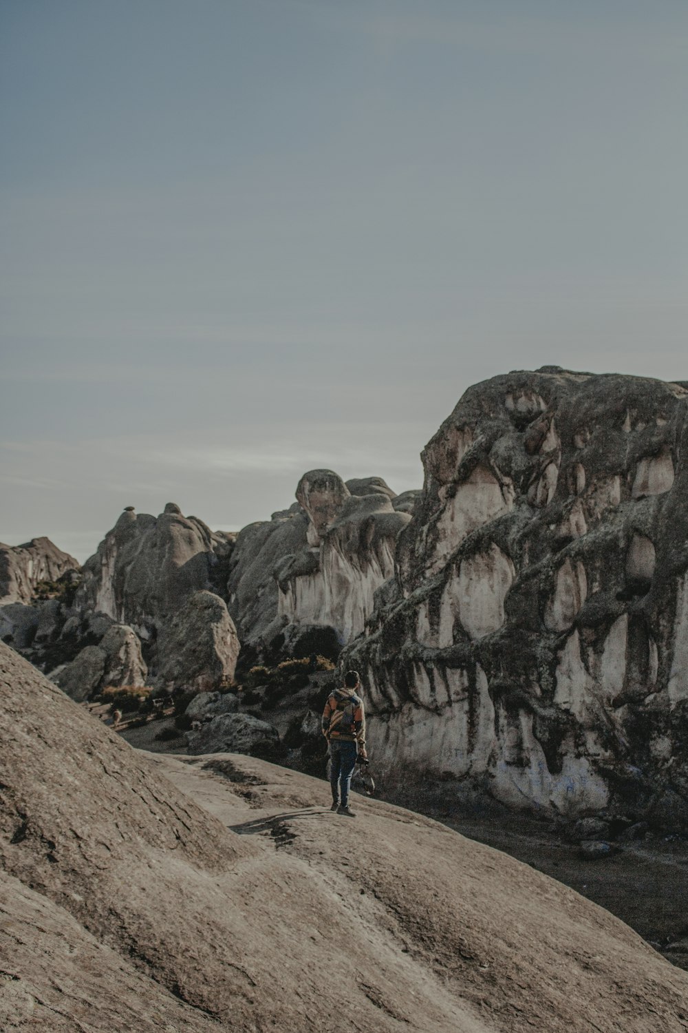 person standing on mountain landscape photograph