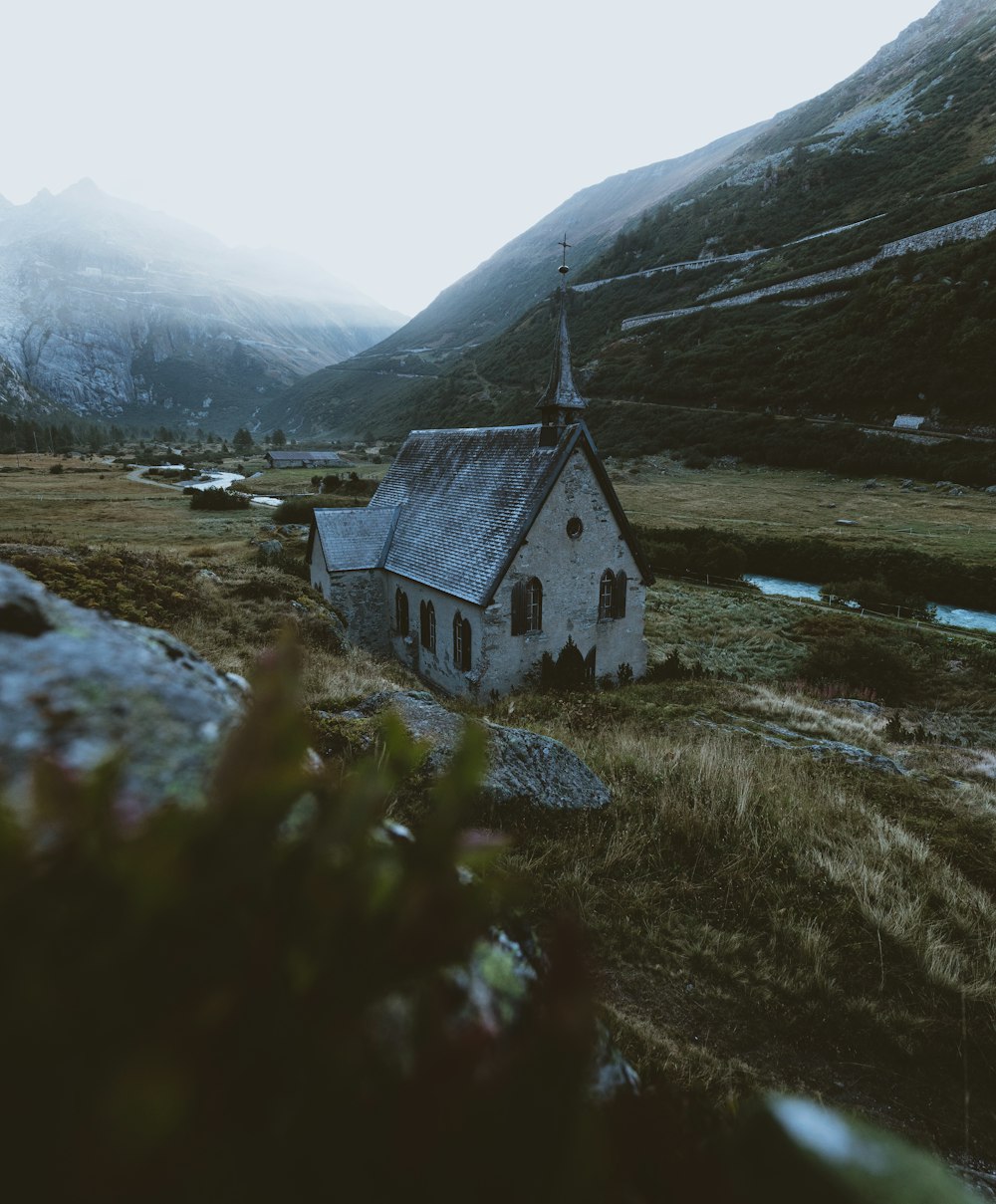 white cathedral surrounded by mountains