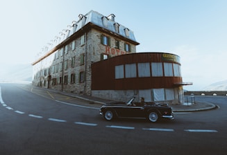 man driving black coupe on empty road