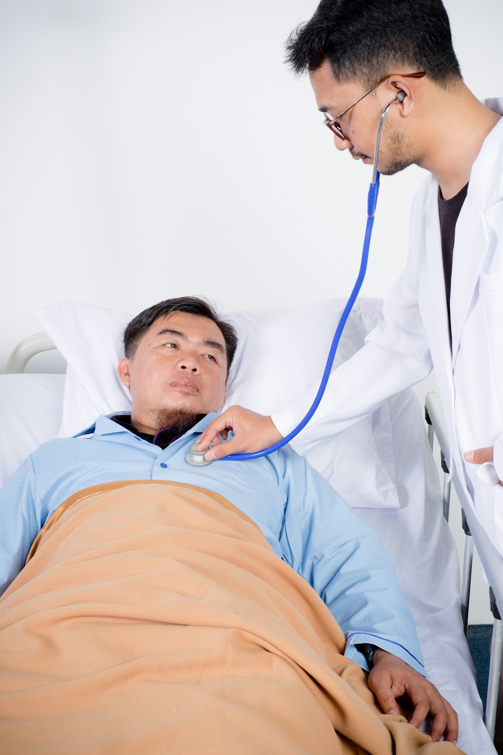 doctor checking maps chest using stethoscope