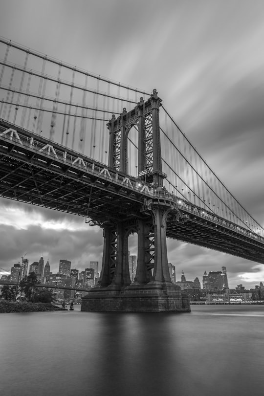 grayscale photo of bridge in Brooklyn Bridge Park United States