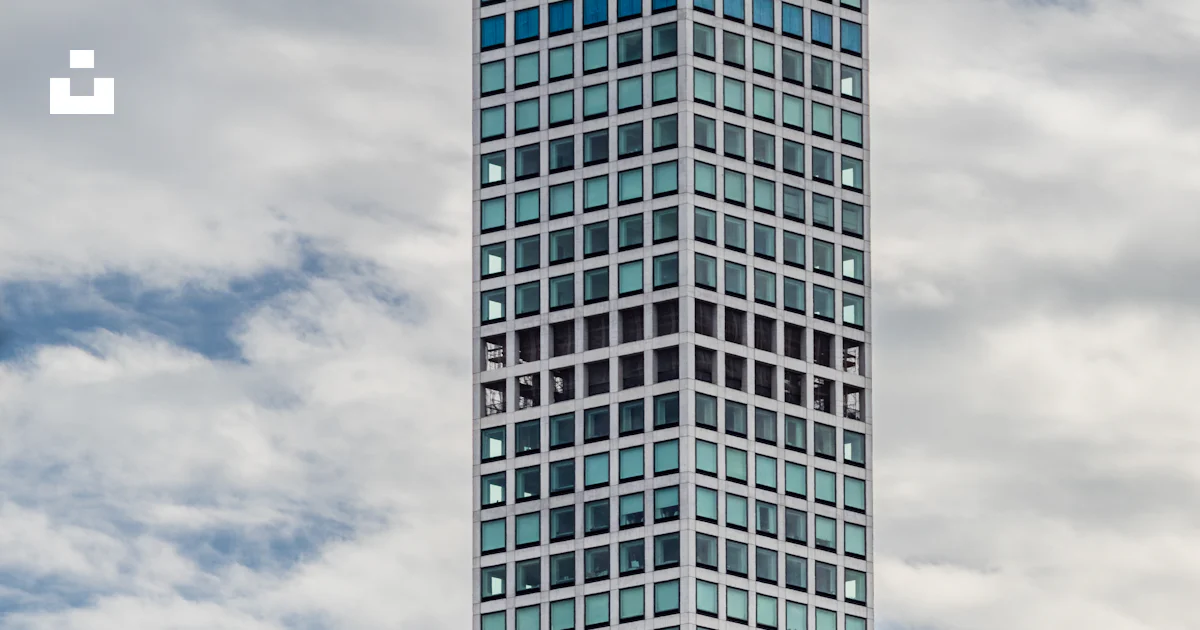 High-rise mirror building under white clouds photo – Free Grey Image on ...