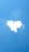 A cloud shaped like a heart against a bright blue sky.