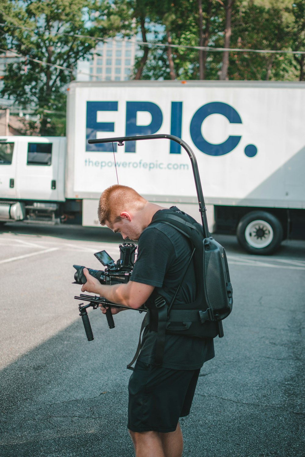 man taking photo near Epic truck