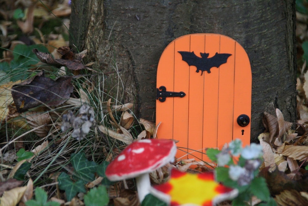 orange door in tree near mushrooms