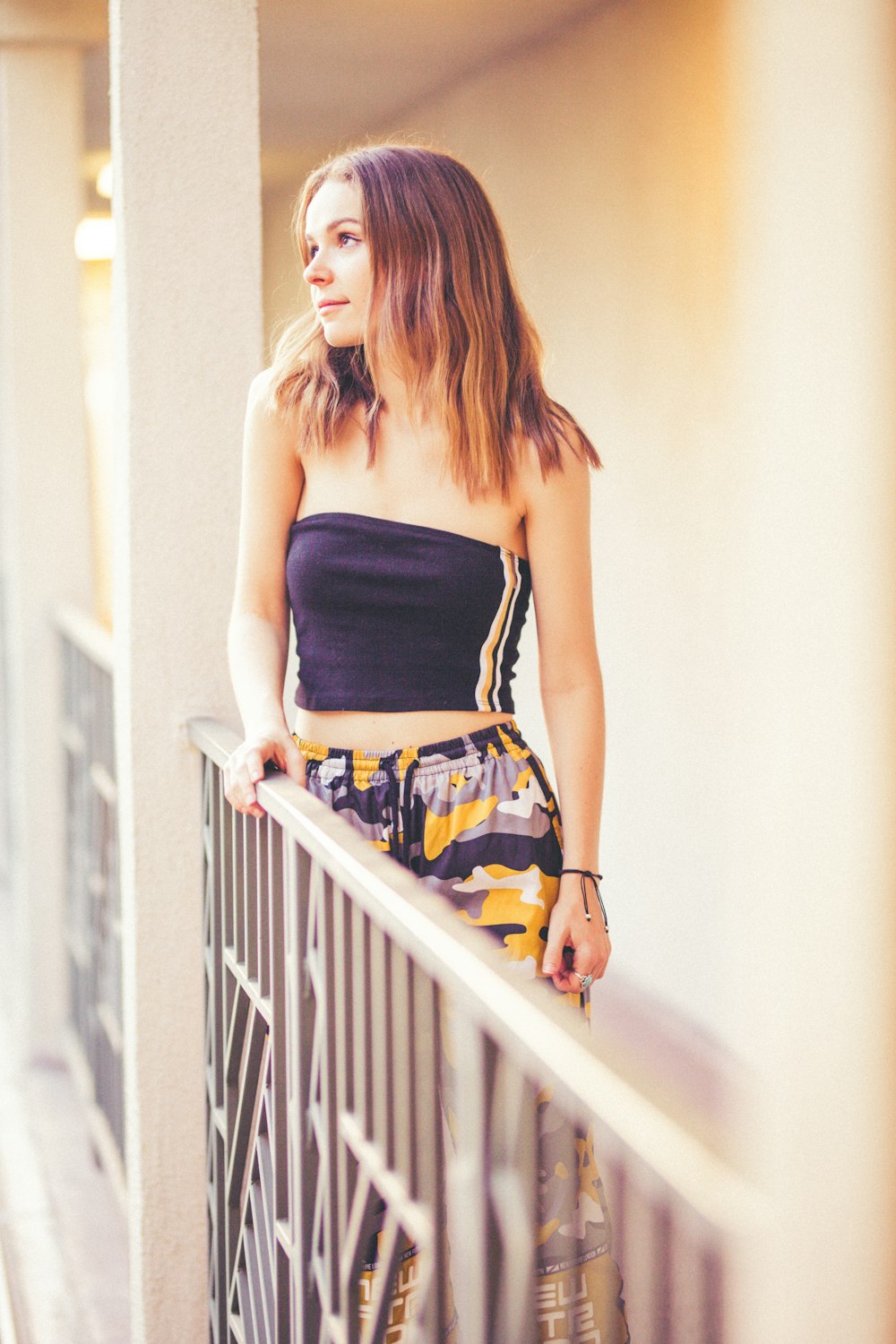 woman standing beside fence