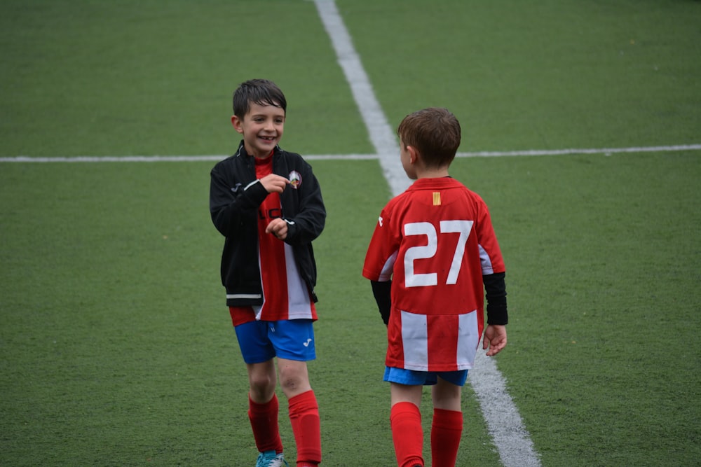 two boy standing on soccer field
