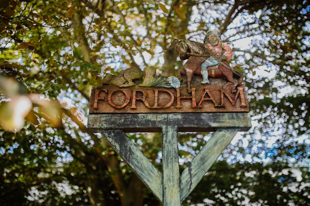 Fordham wooden signage under green tree