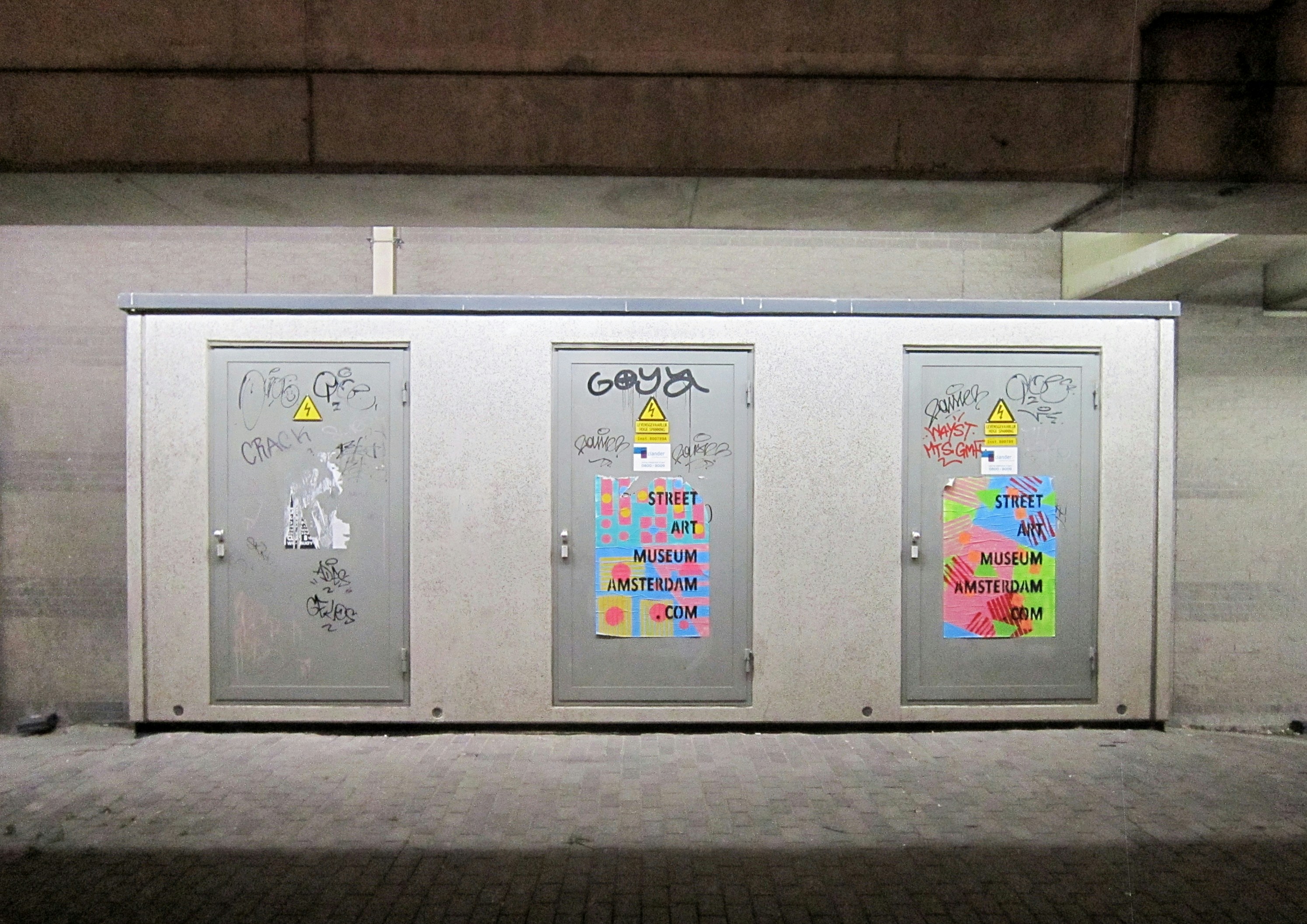 A diverse group of citizens looking at a public display screen in a city square, which shows positive news and updates from the local police force.