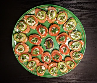 A beautifully arranged platter of Russian appetizers including pirozhki, smoked salmon, and fresh dill garnish.