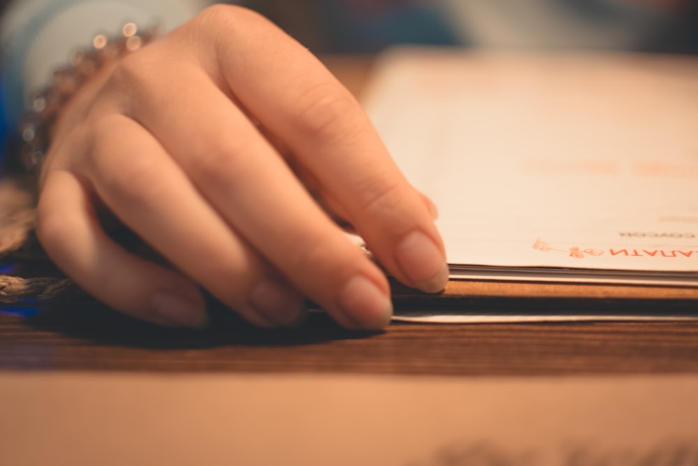 woman touching bookpage