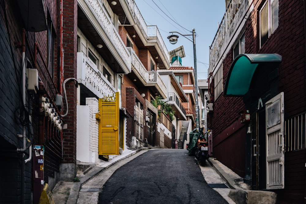 a motorcycle parked on the side of a narrow street