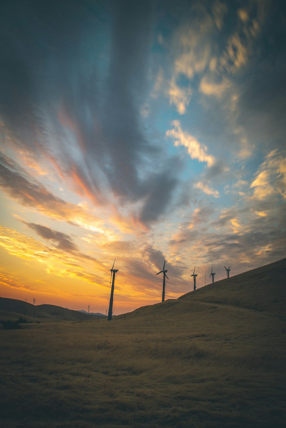 several windmills under cloudy sky