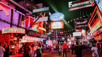 people standing between store buildings at nighttime
